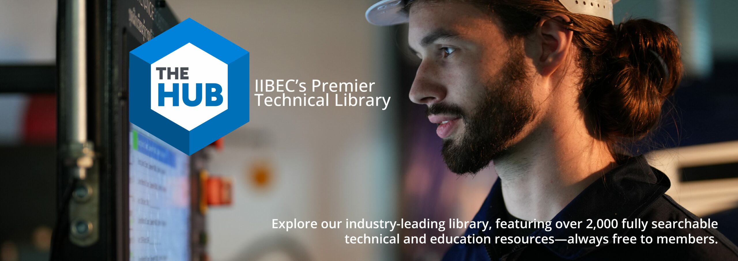 Banner showing man looking at computer screen representing The Hub, IIBEC's technical library.